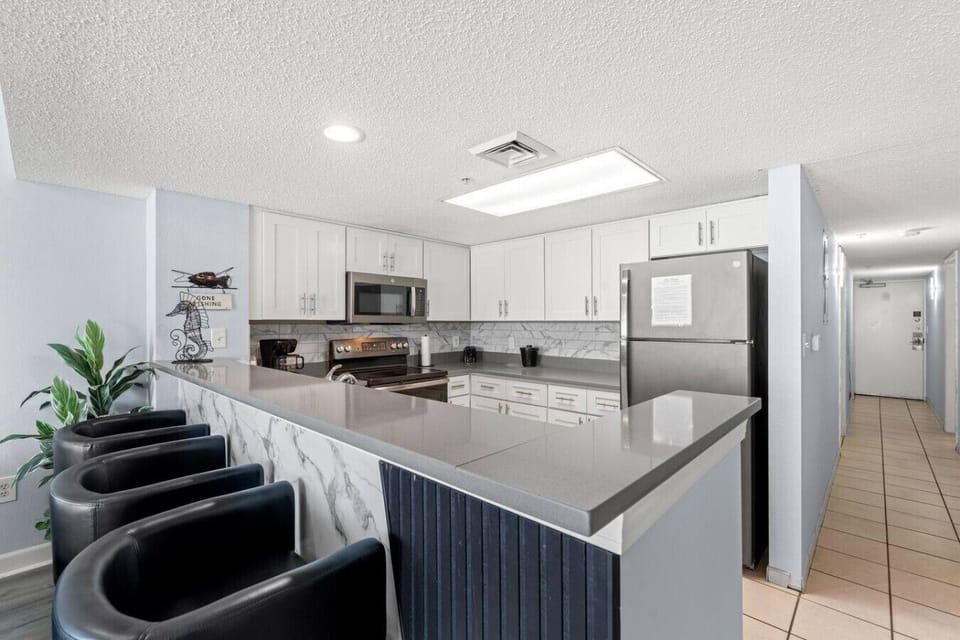 Convenient pull-up bar with stylish seating offers additional dining space, perfect for casual meals, morning coffee, or gathering with family and friends.