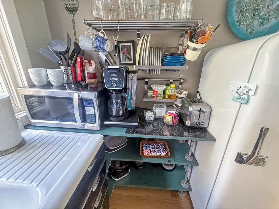 Well-stocked kitchen nook with coffee station and charming retro fridge