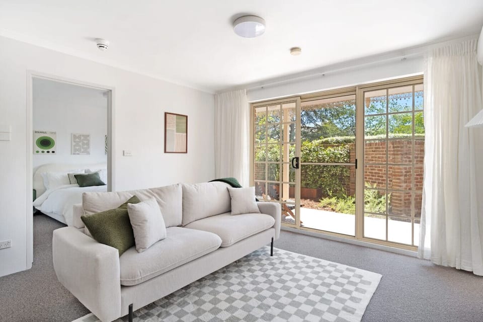 Large windows fill the living area with beautiful natural light, creating a bright and inviting atmosphere.