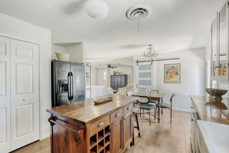 Open kitchen layout with farmhouse sink and easy flow into dining and living areas
