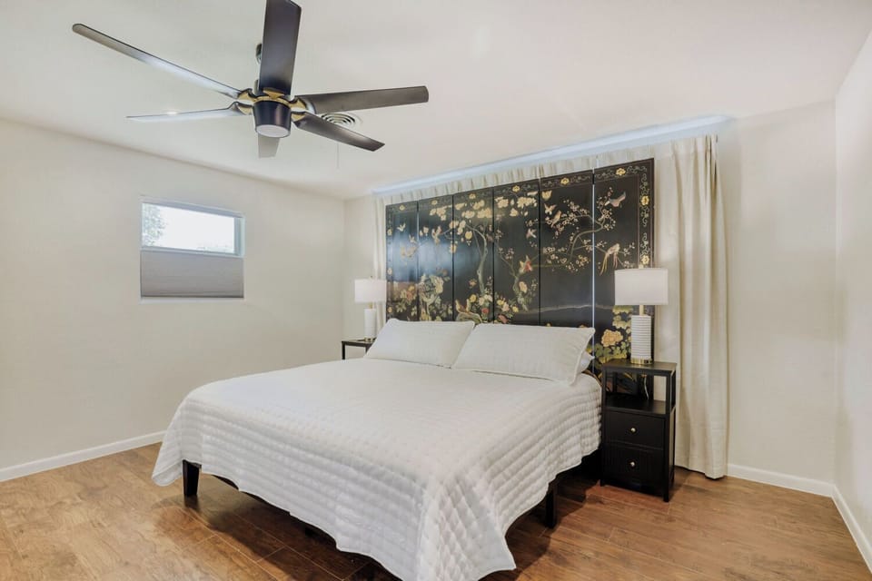 Serene bedroom with a statement headboard and soft, neutral tones for a restful stay.