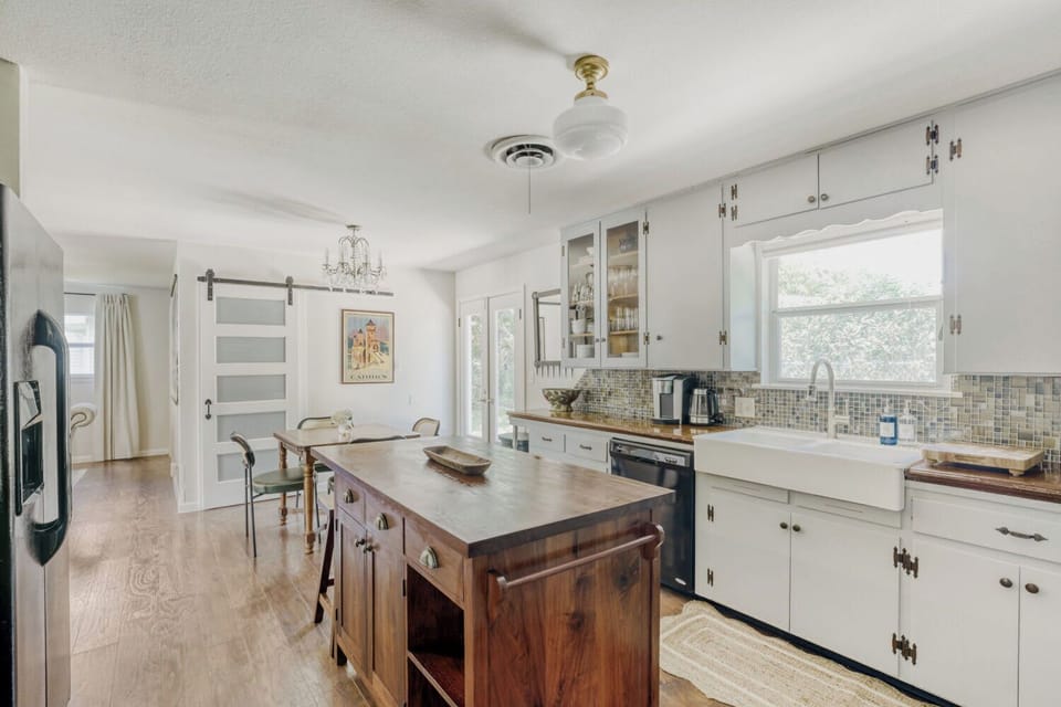 Warm, inviting kitchen with island seating and direct access to the backyard