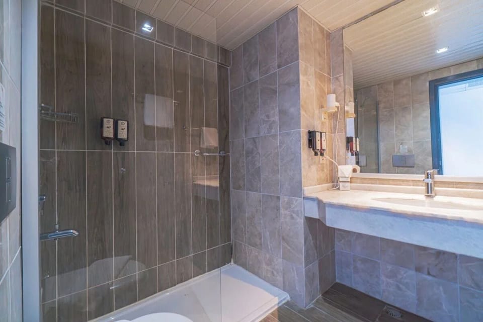 Standard Room, Balcony, Partial Sea View | Bathroom | Shower, free toiletries, hair dryer, slippers