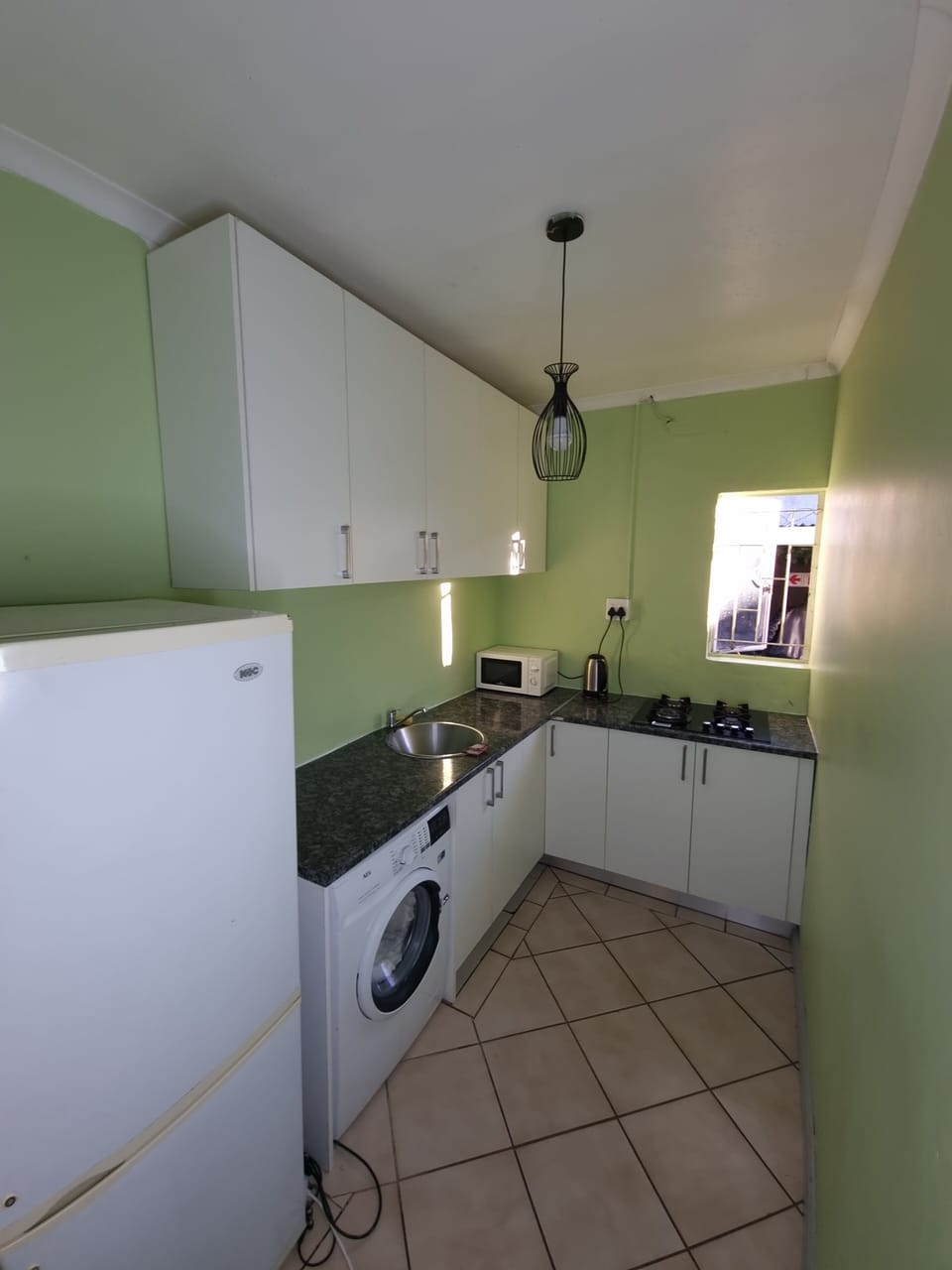 Full-size fridge, microwave, stovetop, cookware/dishes/utensils