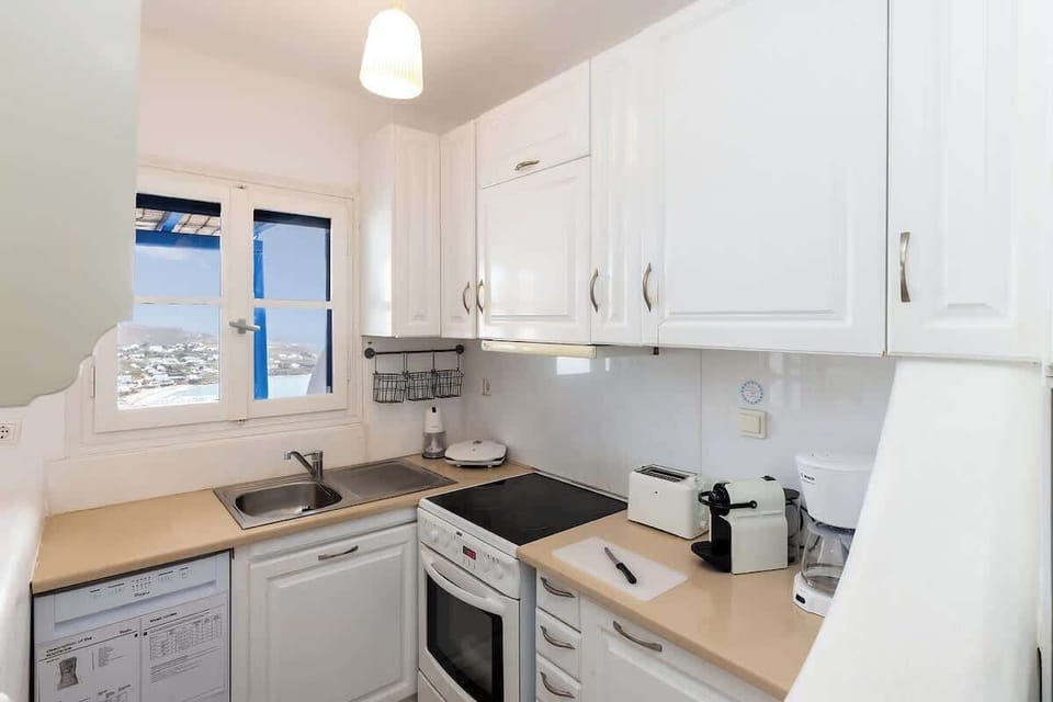 Fully Equipped Modern Kitchen with White Finishes
