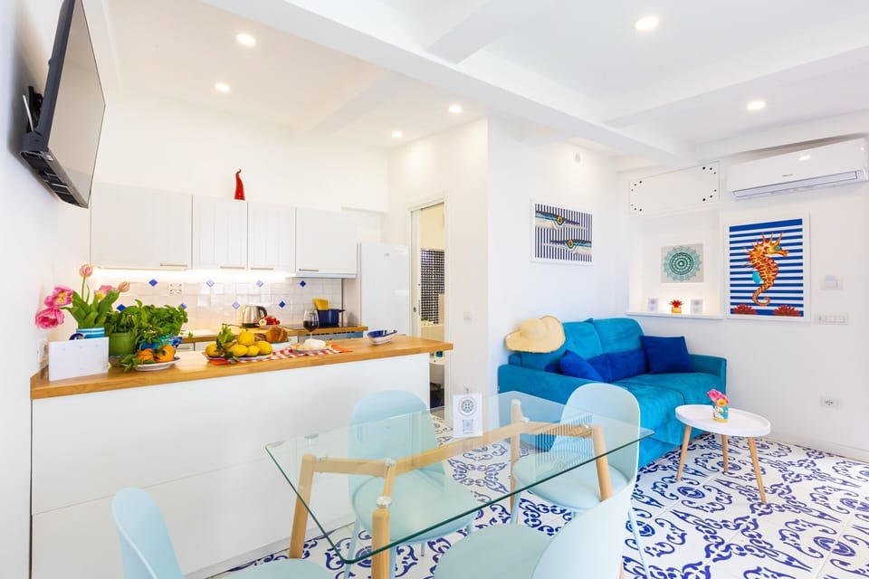 Deluxe Apartment, Sea View | Living area | 32-inch flat-screen TV with digital channels
