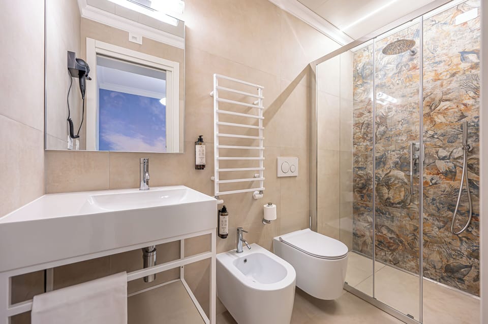Deluxe Single Room | Bathroom | Shower, hair dryer, slippers, towels