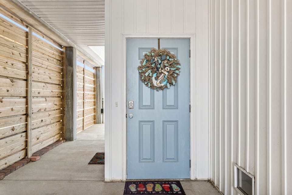 Front Door to townhome with underneath carport 