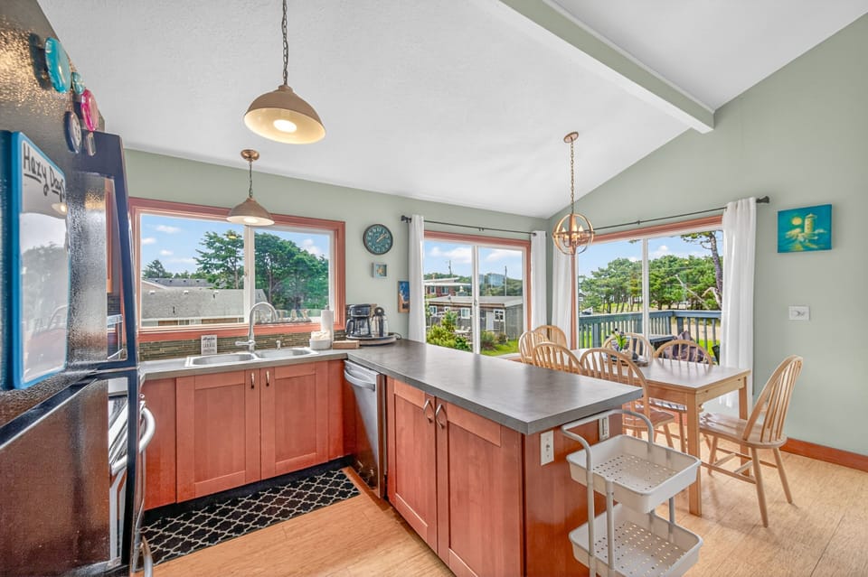 Your bright kitchen flows seamlessly into the dining area, where morning coffee tastes better with peaceful views through large windows.