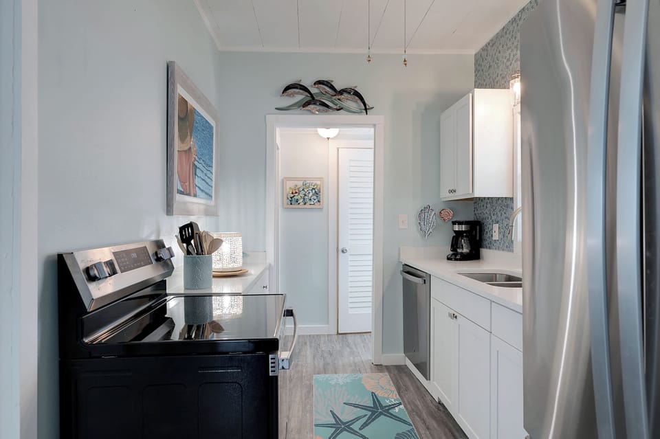 Full size appliances including smooth top range, refrigerator and dishwasher
