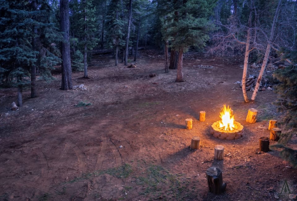 Watch the fire glow from the deck at twilight — a magical elevated vantage point on what may be the best seat in Duck Creek Village.