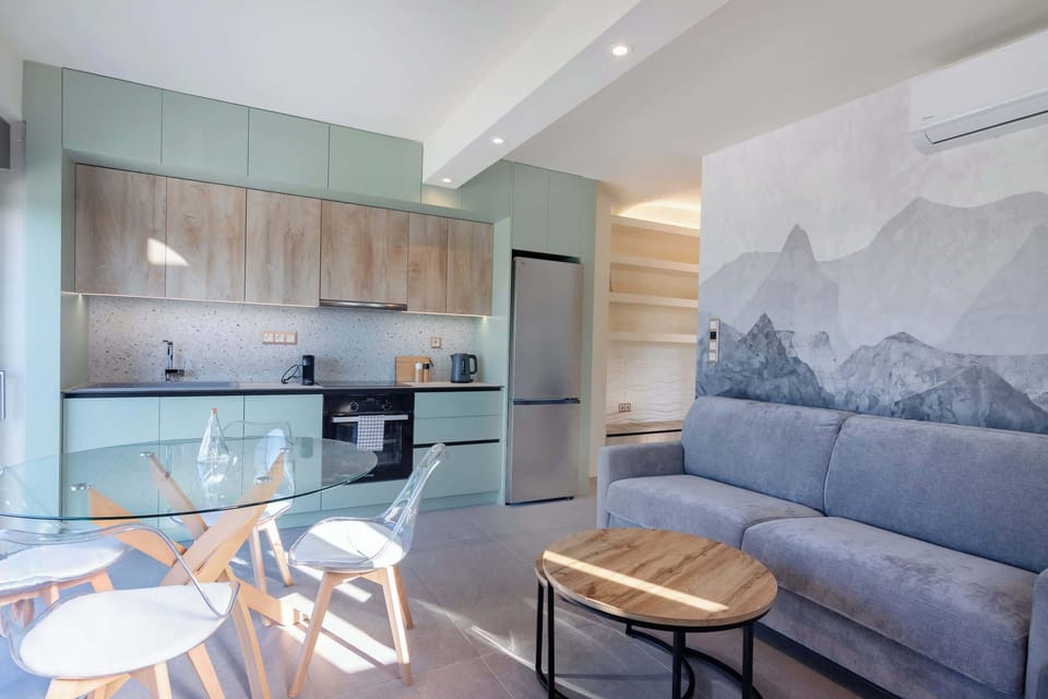Bright Living Area with Open-Plan Kitchen & Soft Tones
Modern and inviting living space with a cozy sofa, natural light, and a fully equipped open-plan kitchen, designed with soft, calming tones to create a comfortable and stylish indoor environment
