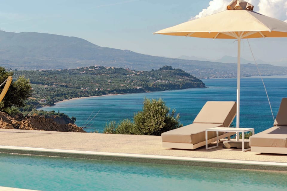 Shared  Pool with Coastal Views and Shaded Seating