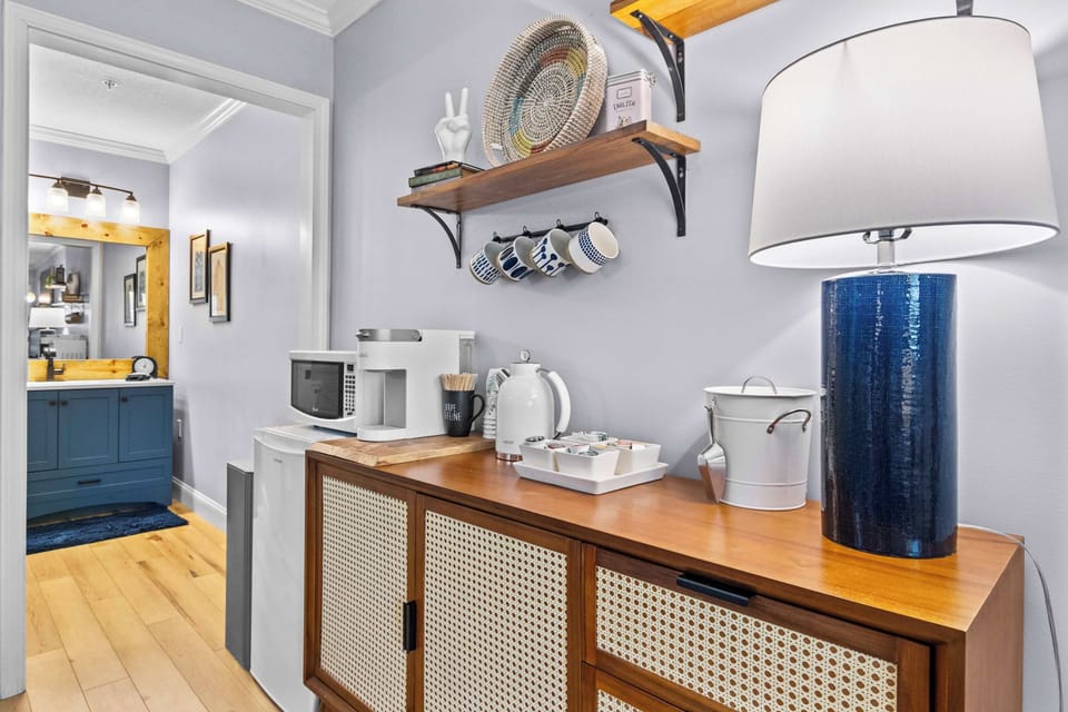 Kitchenette with a Keurig, microwave, and mini fridge. Quiet mornings start here.