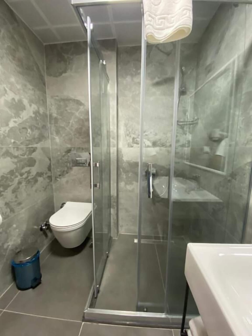 Shower, hair dryer, slippers, towels