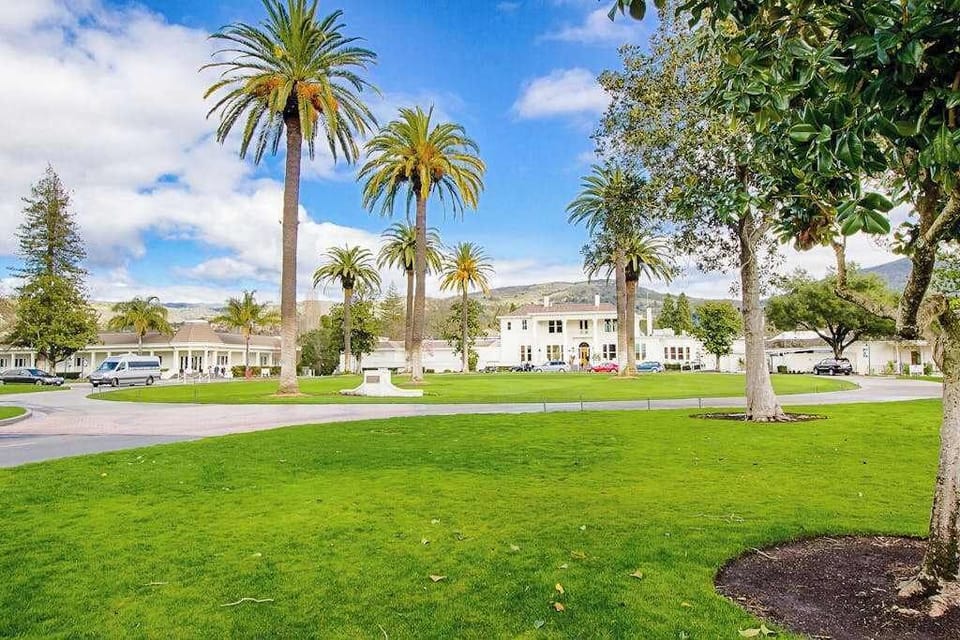Wander beneath towering palms across Silverado's historic grounds — the resort's storied mansion and sweeping lawns capture the spirit of Napa Valley.
