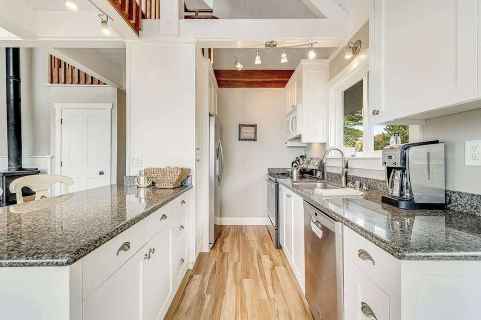 Brew your first cup from the coffee maker and prep Spud Point crab on polished granite counters — this galley kitchen has everything your coastal menu demands.