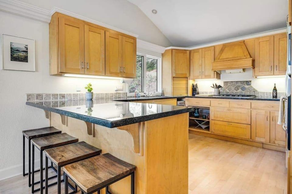 Pull up a stool at the granite breakfast bar and watch your personal chef work — a built-in wine rack keeps your Cloverdale tasting room finds within easy reach.