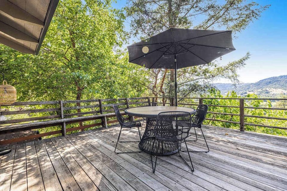 Savor your morning coffee at the shaded deck table while sweeping mountain and valley views stretch across Cloverdale's rolling wine country landscape.