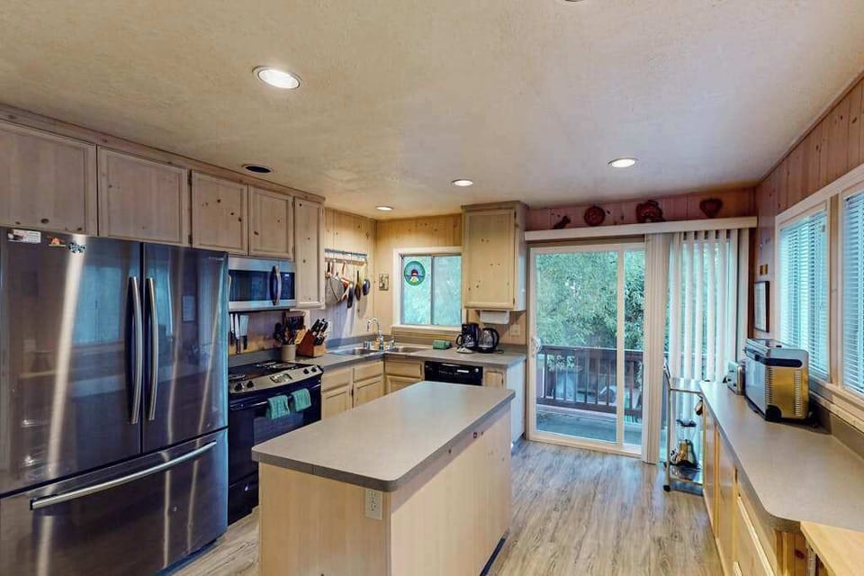Stock your stainless-steel fridge with local Sonoma County provisions and cook with a view — sliding glass doors open straight to the deck.