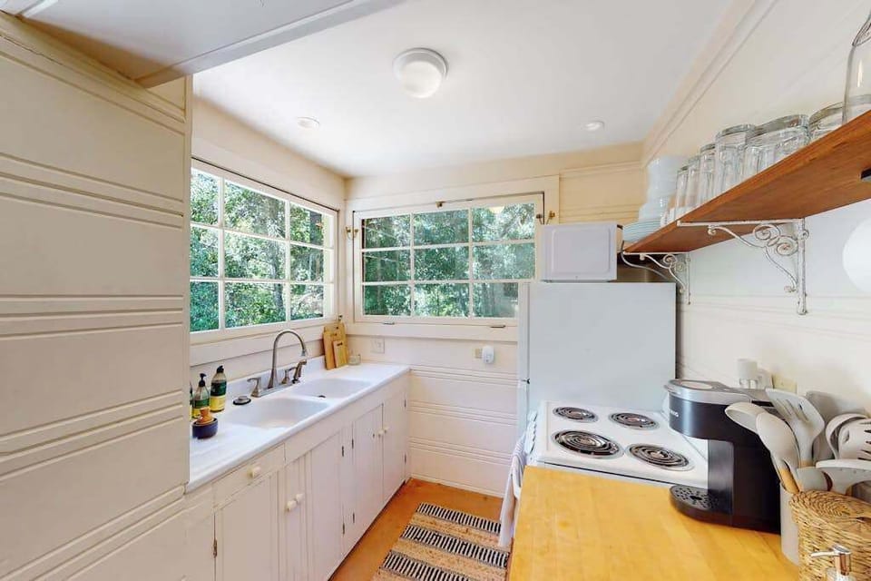 Whip up farm-to-table meals in your fully equipped galley kitchen — the window above the sink frames a living wall of green that makes prep work a pleasure.