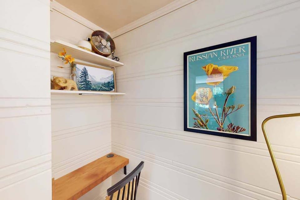 Local flair meets personal workspace — a vintage Russian River poster and display shelf keep the spirit of Sonoma's river country alive right in your bedroom.
