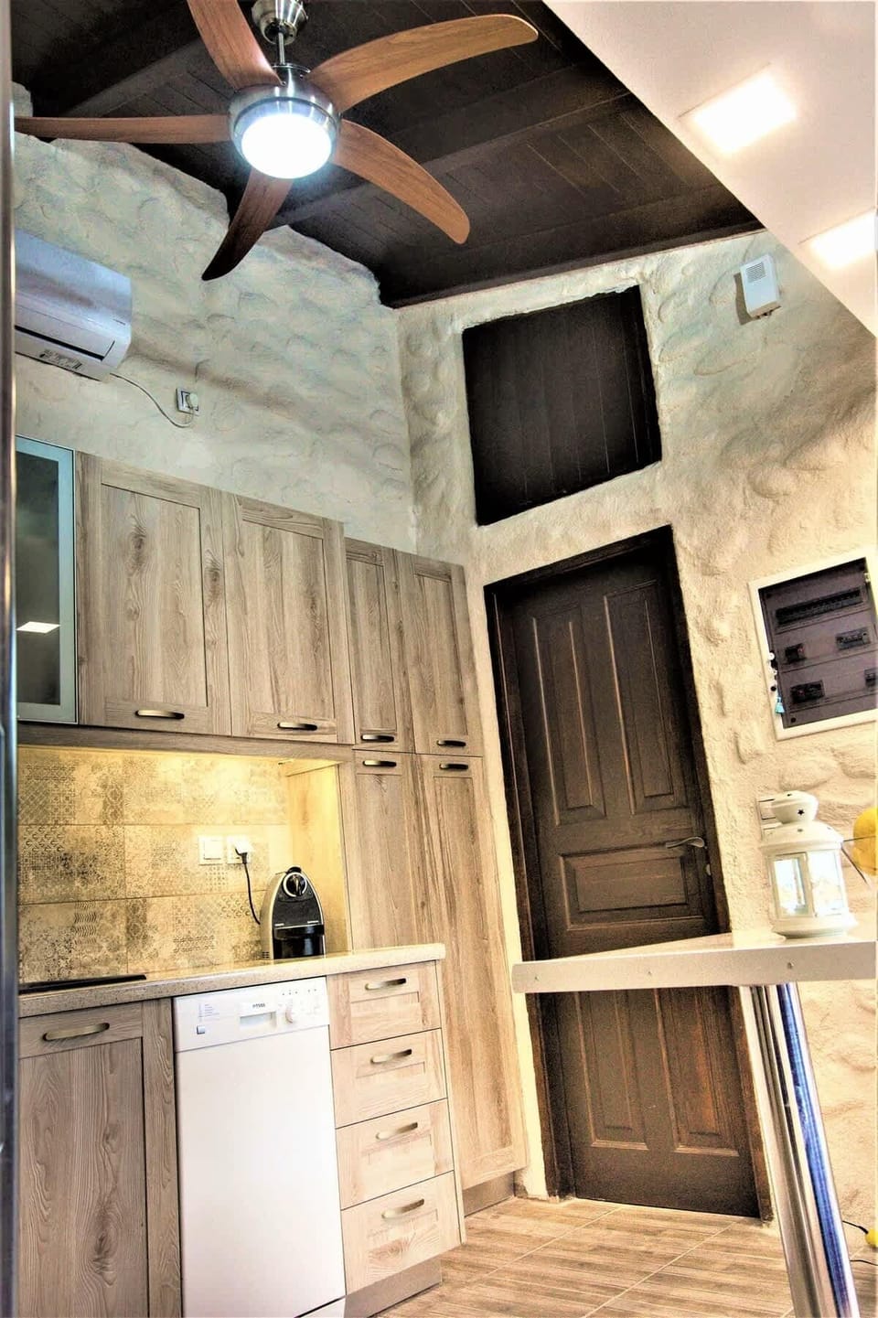 Close view of the kitchen setup, highlighting the materials and layout designed for practical daily use, with air-conditioning throughout and ceiling fans with remote control.