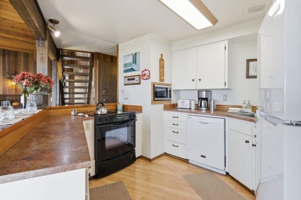 Kitchen | Electric Range | Wood Countertops & White Cabinetry