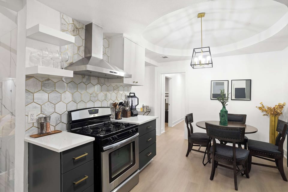 Chef-ready kitchen with sleek finishes, statement backsplash, and cozy breakfast nook for easy mornings.