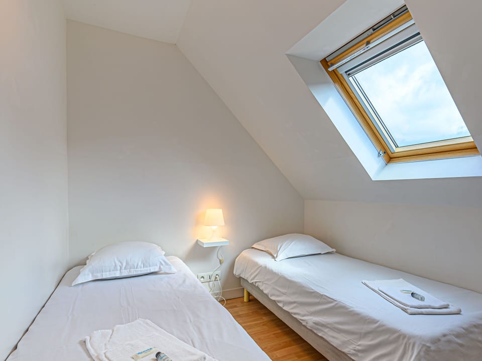 Two single beds on the upper floor — bike helmets ready for the coastal paths around Pentrez