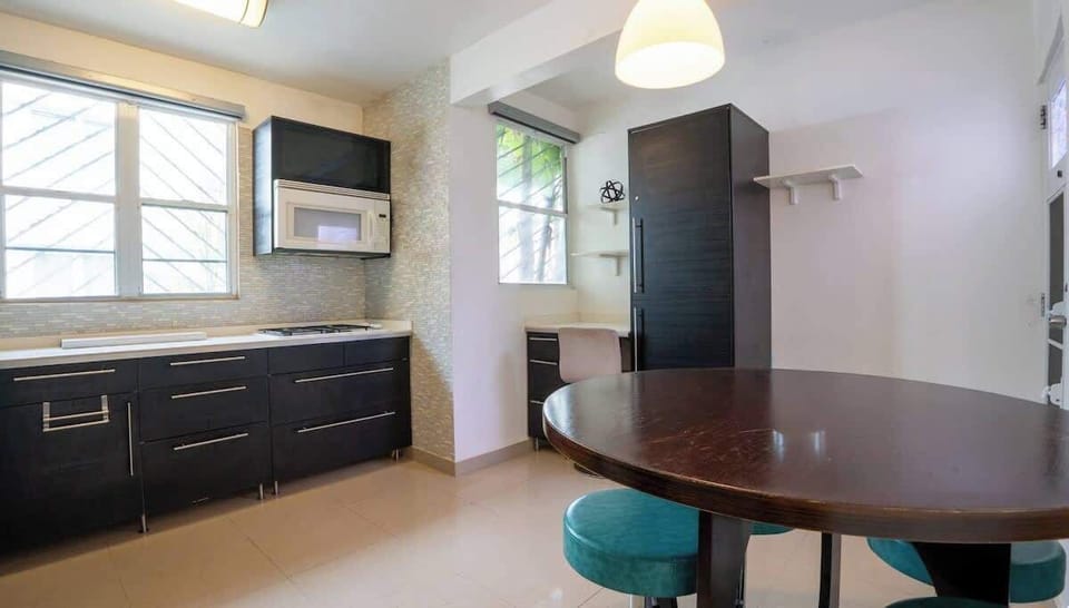 Enjoy meals together around the dining table just off the kitchen.