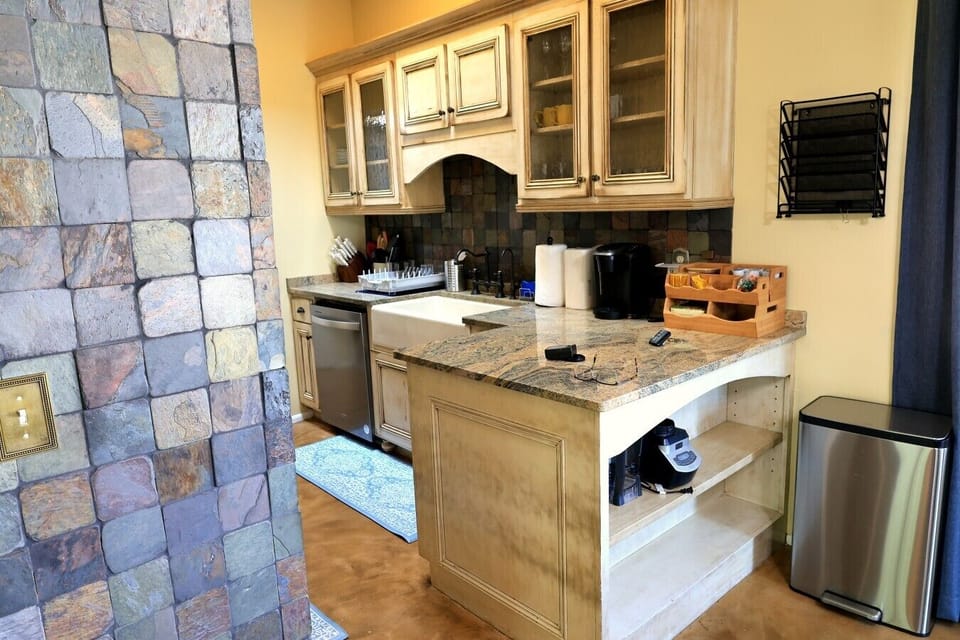 Custom cabinetry with natural stone accents and granite countertops