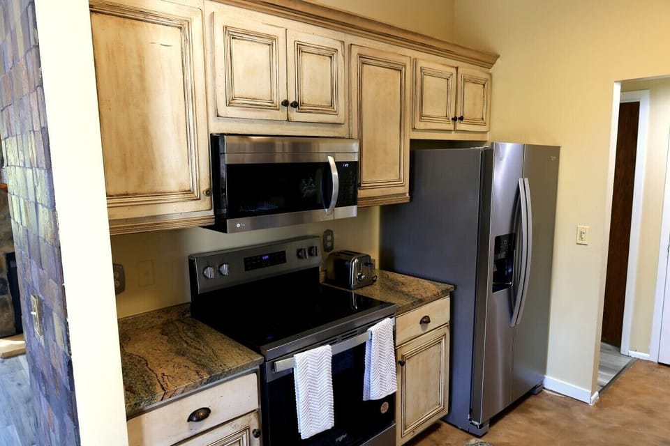 Stainless-steel appliances including stove, microwave, and French door fridge