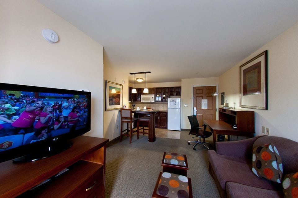 Unwind in your welcoming living area, complete with a comfortable sofa and a TV, perfect for movie nights.