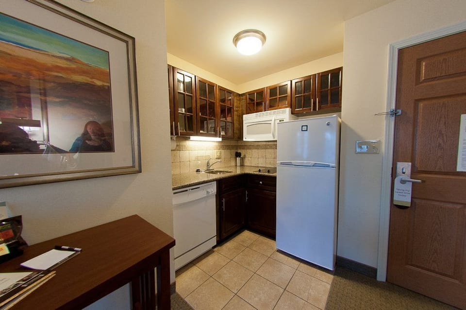 Cook up a storm in your fully equipped kitchenette, showcasing sleek appliances and ample storage for your culinary needs.