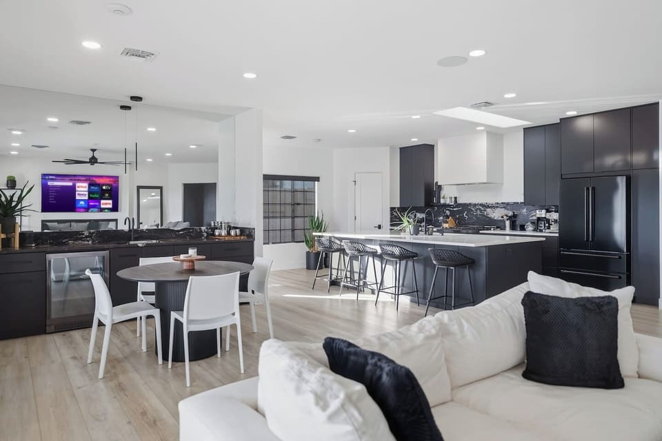 Designer kitchen featuring a large island with four barstools and high-end finishes.
