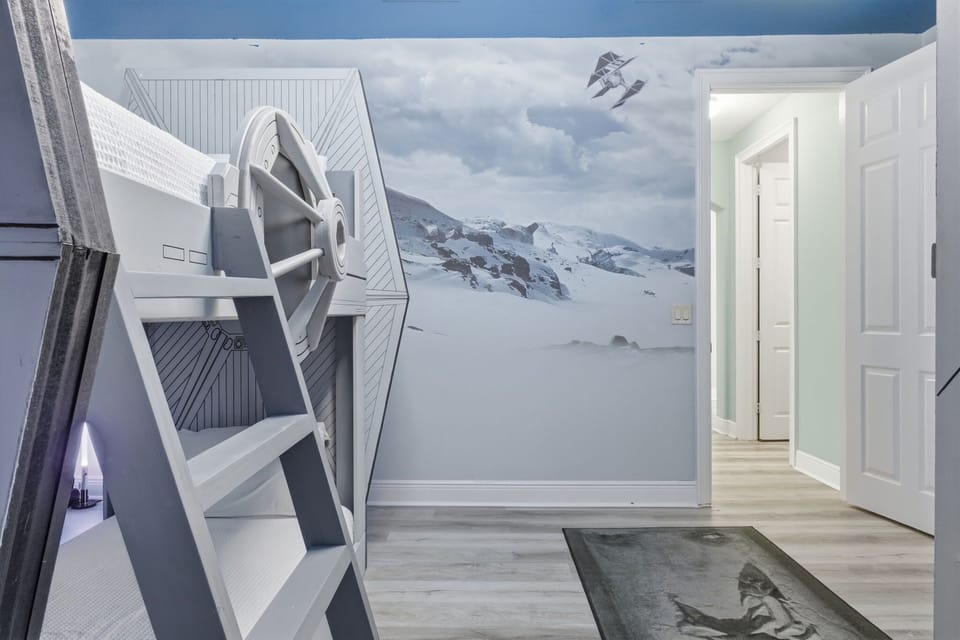 Immersive galactic-themed bunk room featuring custom-built pods and spaceship design—perfect for kids and teens.