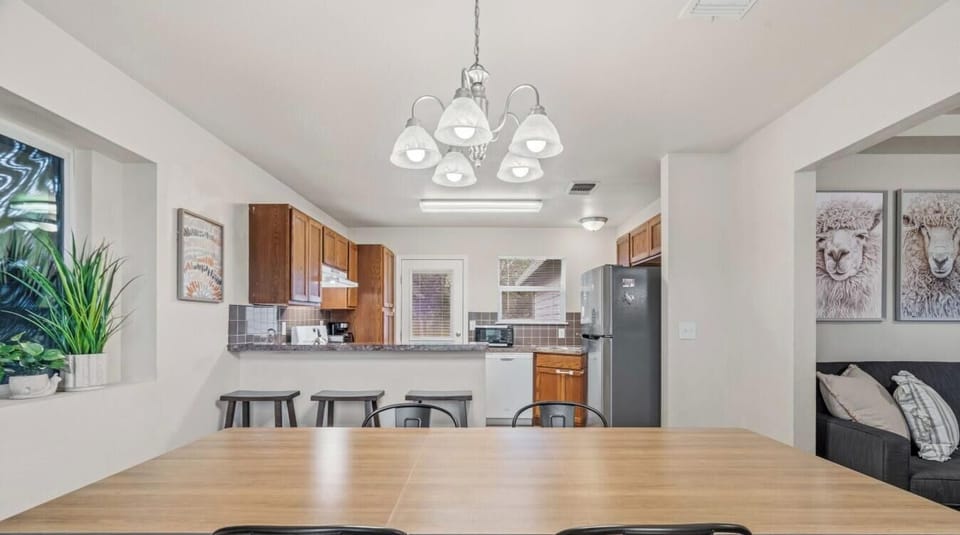 Wide reverse views show the open flow connecting dining, kitchen, and second living space.