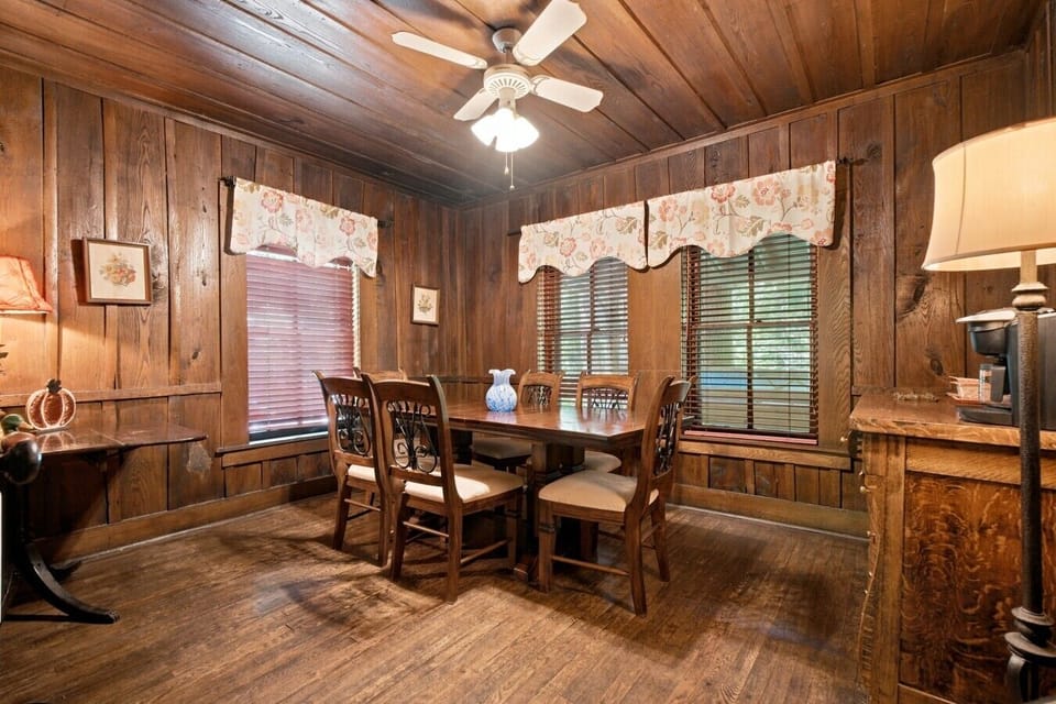 Main House Dining Area | Hardwood Floors | Ceiling Fan & Wood-Paneled Walls