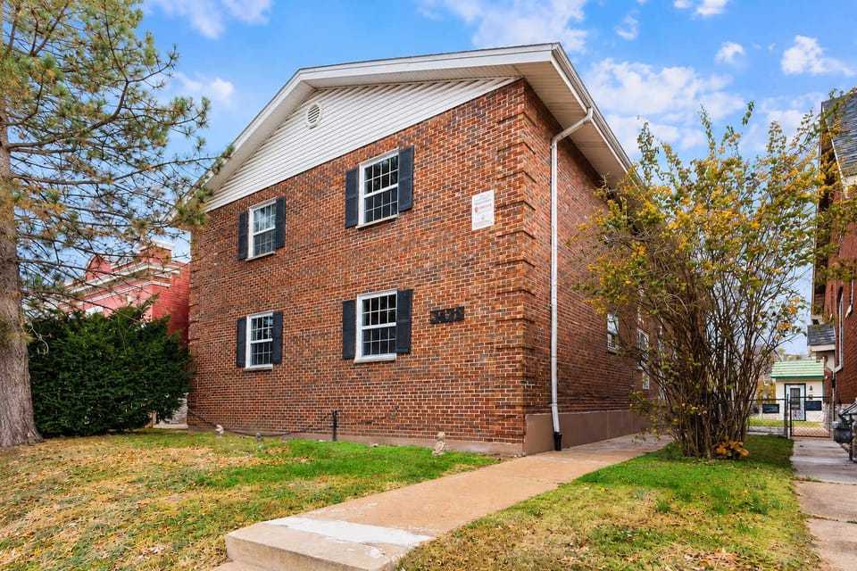 Brick exterior on Morganford Rd — free street parking + reservable rear spots
