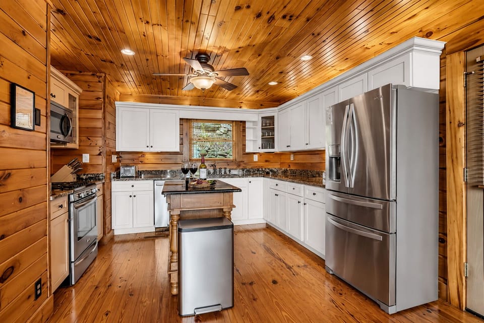 A fully equipped chef's kitchen with stainless appliances, a center island, and 