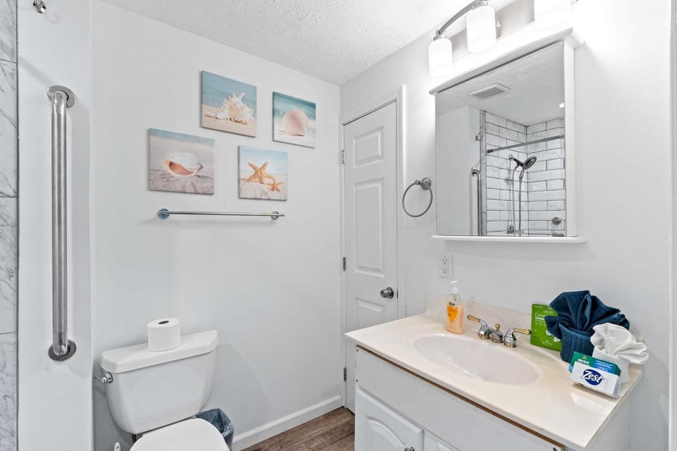 The bathroom features a bright, clean design with plenty of natural light.