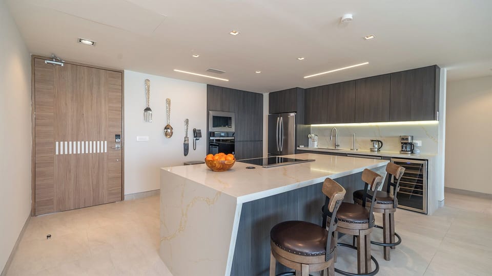 The kitchen is a chefs dream, stainless steel appliance, worth fridge, bar stools