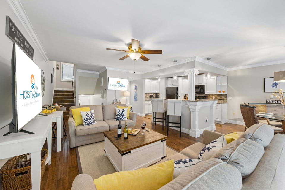 With two sofas, a TV, and an open flow into the dining and kitchen areas, it's the perfect place to unwind after beach days or tee times.