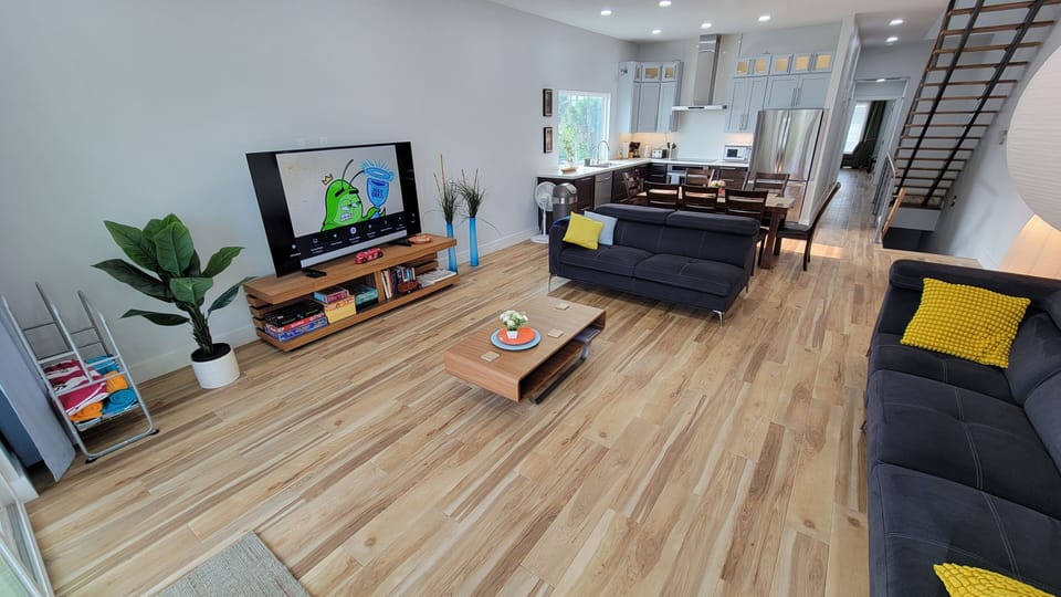 Living room, 75'' TV, Kitchen, Staircase, hallway.