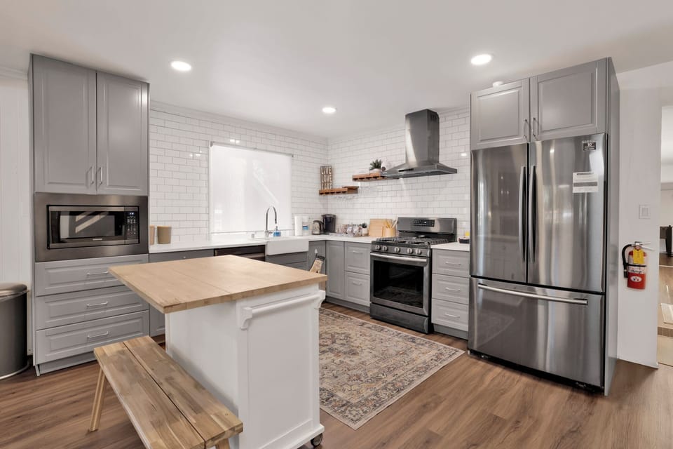 Cook like a pro in this large gourmet kitchen featuring  island, bar seating, and stainless appliances. Plenty of space for the whole group to prep meals together.