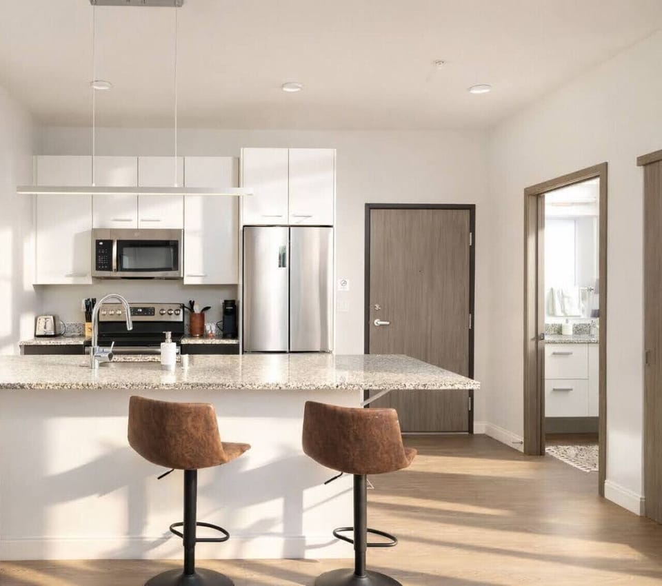 A fully-equipped kitchen with bar stool seating—everything you need to prep, cook, and refuel
