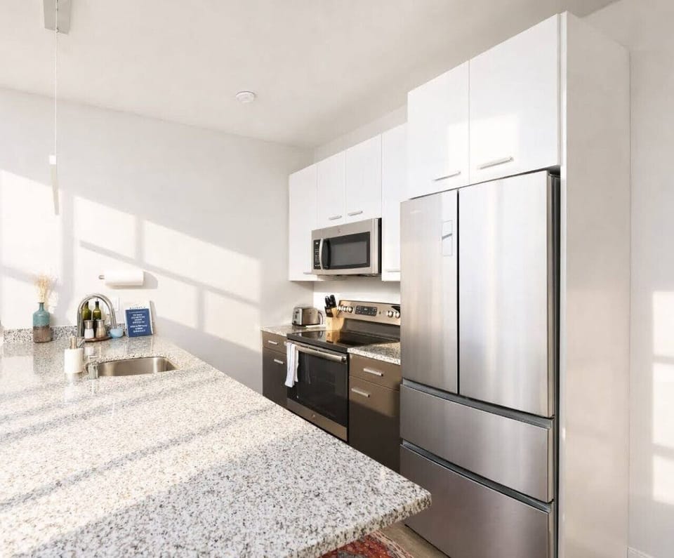 A fully-equipped kitchen with bar stool seating—everything you need to prep, cook, and refuel