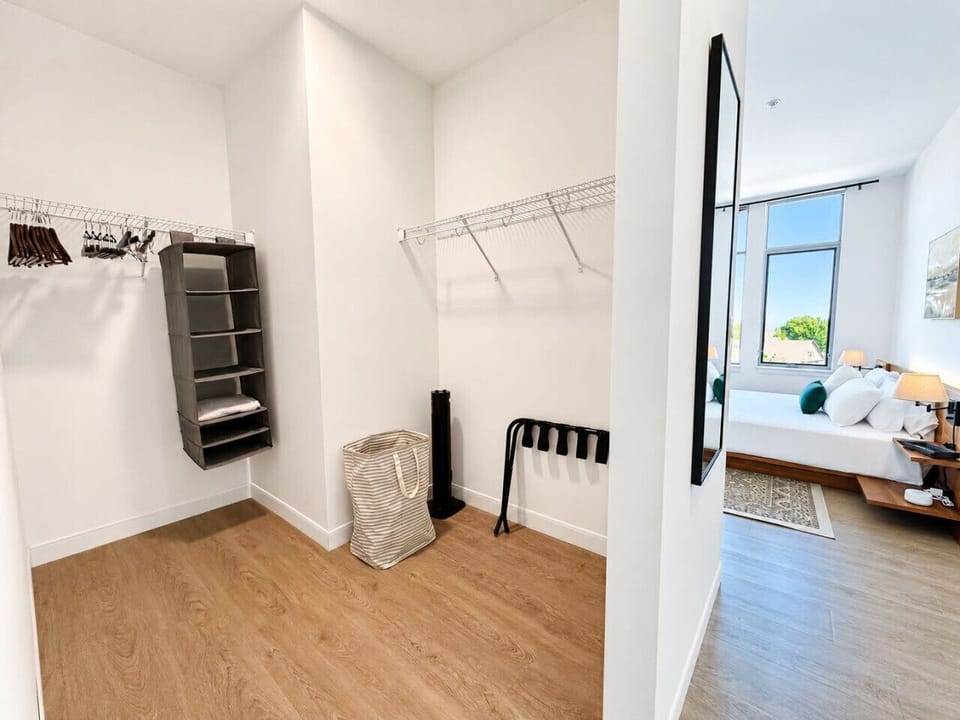 Bedroom #2 is a serene sanctuary featuring a premium queen bed, flat-screen TV, en-suite bathroom, and walk-in closet