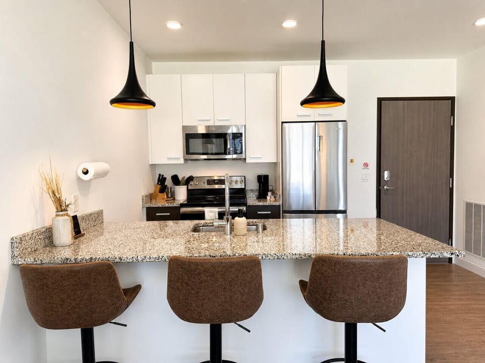 A fully-equipped kitchen with bar stool seating—everything you need to prep, cook, and refuel
